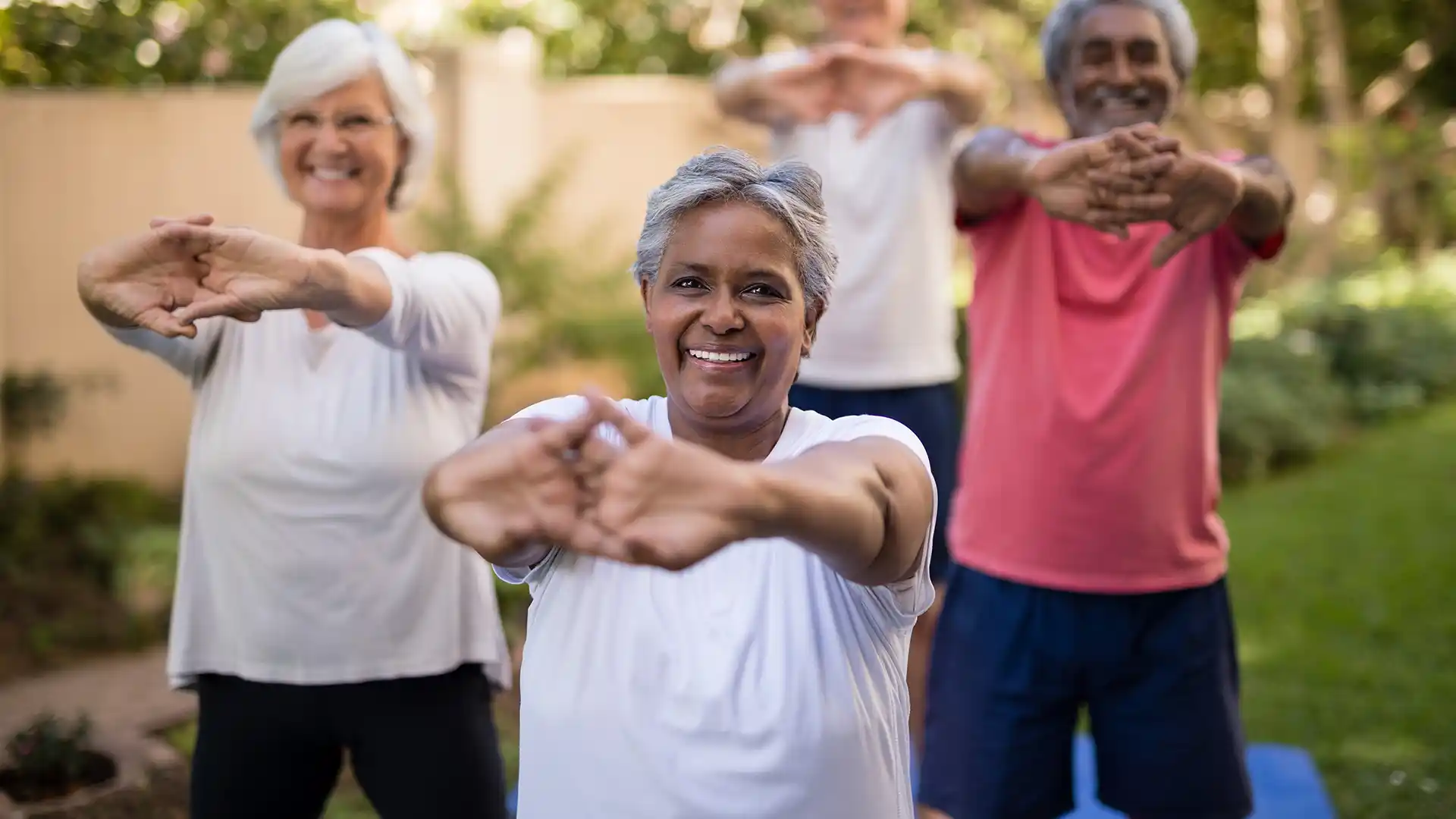 Group of retired individuals stretching outside