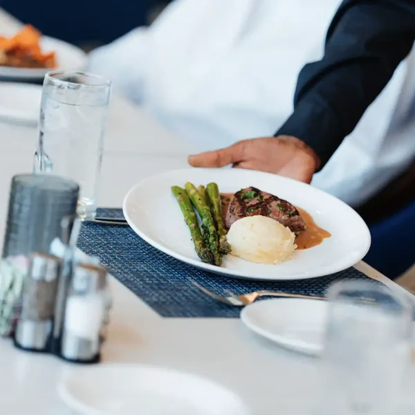 A plated dish of chicken and asparagus is served at a dining venue