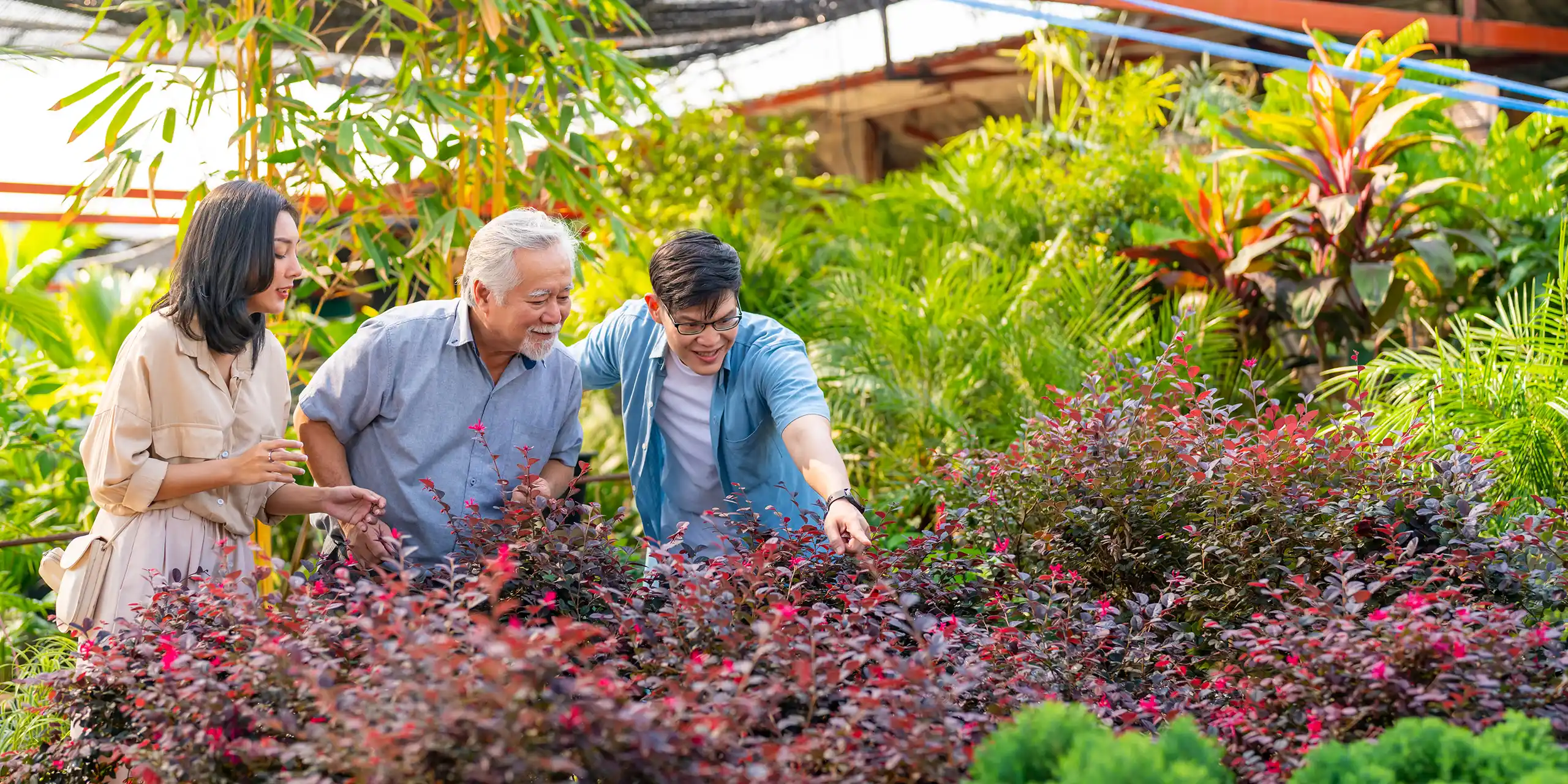 Retired man with adult children at a greenhouse