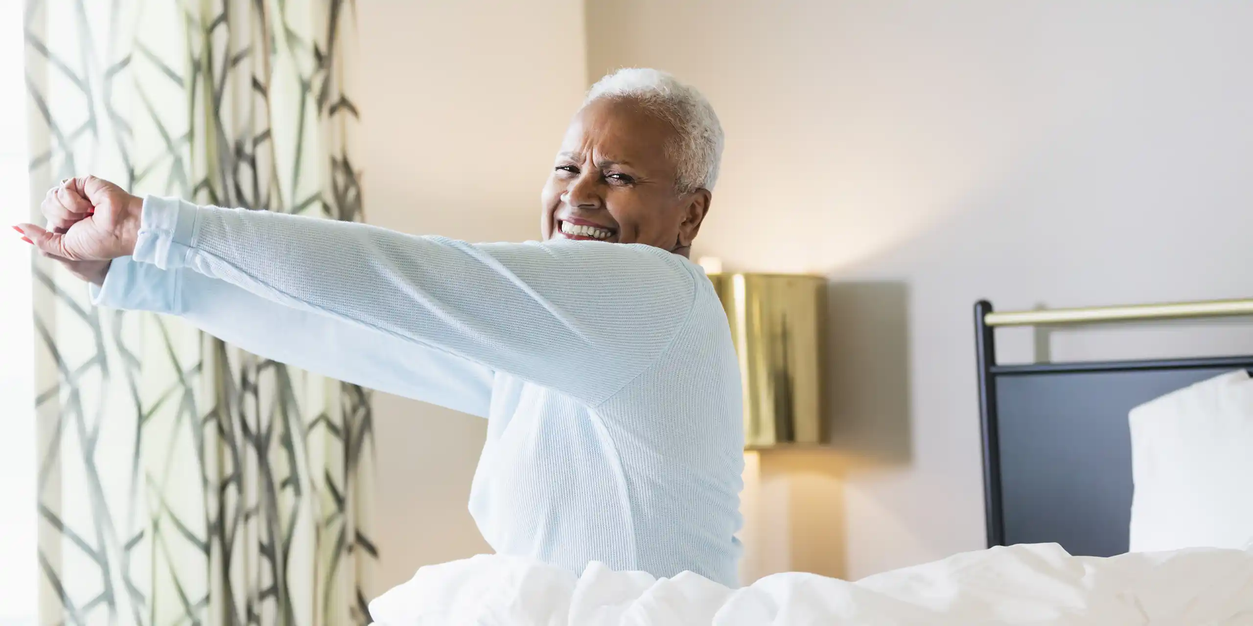 Retired woman waking up and stretching