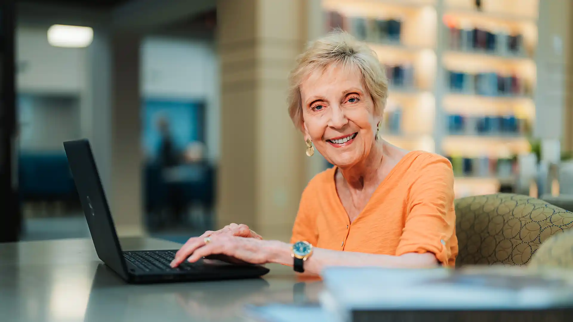 Woman in the PVN library with a laptop