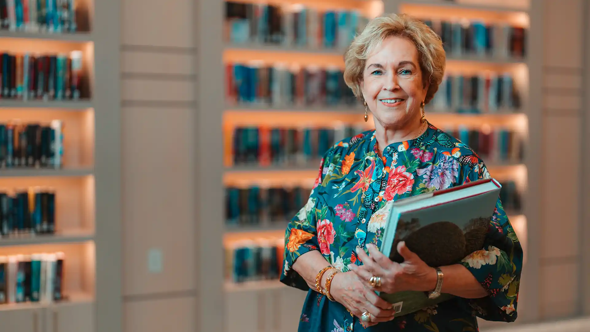 PVN resident holding a book in the library